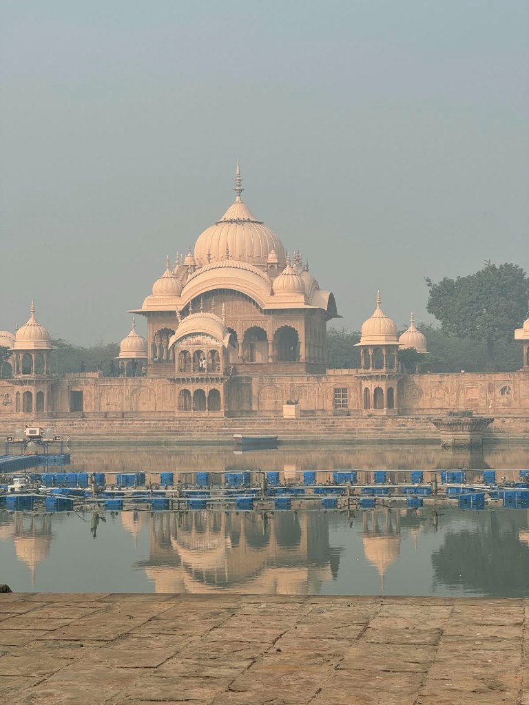 Sandstone domed pavilion reflected in still water