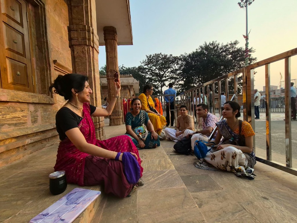 Devotees seated together on stone temple steps